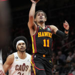 
              Atlanta Hawks guard Trae Young (11) shoots as Cleveland Cavaliers center Jarrett Allen (31) watches during the first half of an NBA basketball game Friday, Feb. 24, 2023, in Atlanta. (AP Photo/John Bazemore)
            