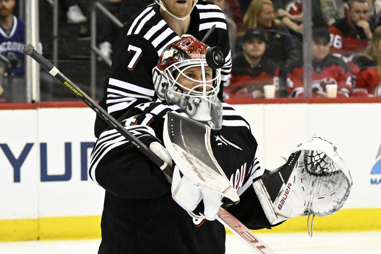 New Jersey Devils goaltender Vitek Vanecek (41) watches the puck as he makes a save during the firs...