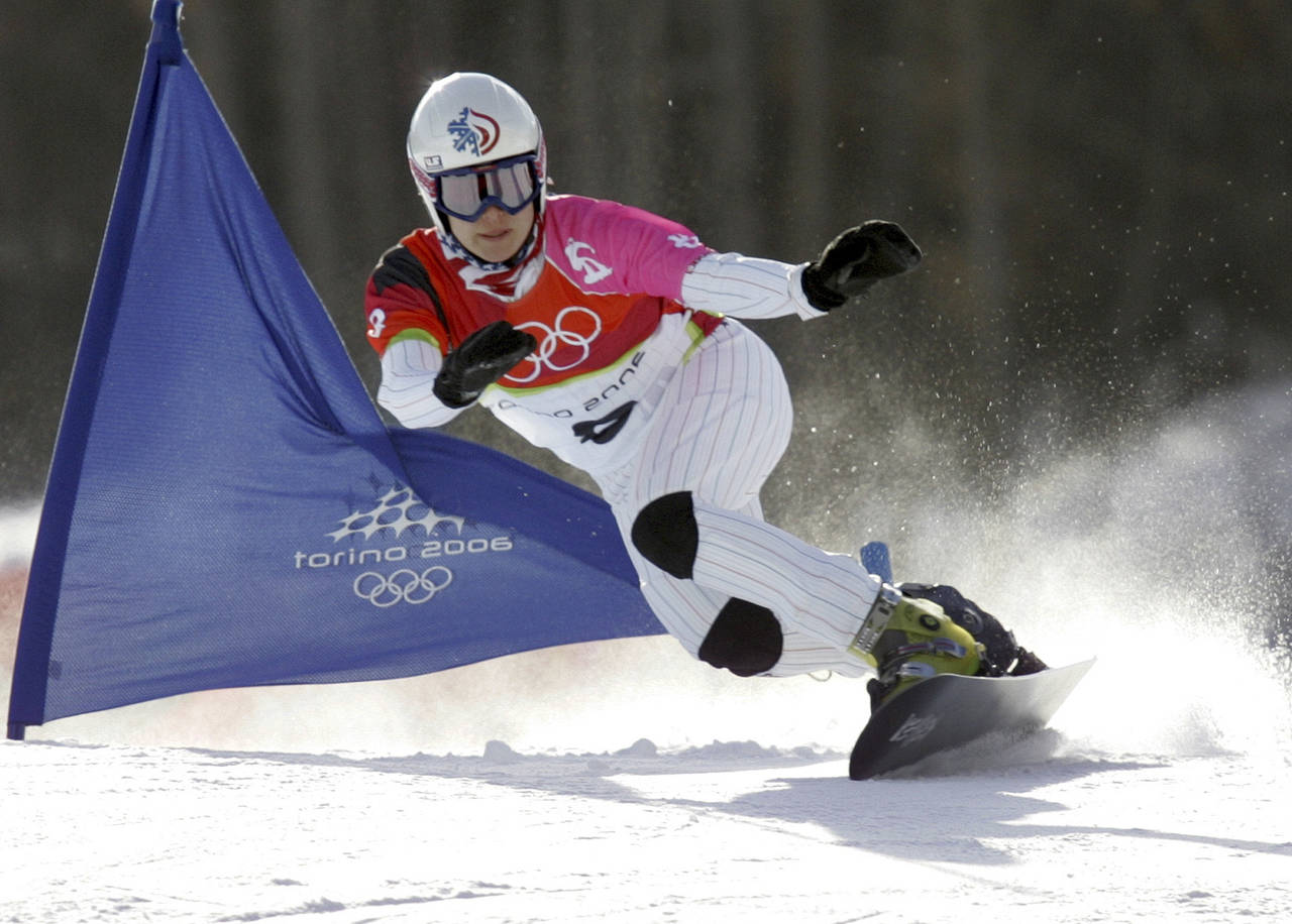 FILE - United States Rosey Fletcher clears a gate during the women's snowboard parallel giant slalo...