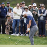 
              Jon Rahm, of Spain, chips onto the third green during the third round of the Genesis Invitational golf tournament at Riviera Country Club, Saturday, Feb. 18, 2023, in the Pacific Palisades area of Los Angeles. (AP Photo/Ryan Kang)
            