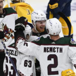 
              Arizona Coyotes left wing Lawson Crouse (67) celebrates after his goal with Matias Maccelli (63) and Patrik Nemeth (2) during the third period of an NHL hockey game against the Nashville Predators, Monday, Feb. 13, 2023, in Nashville, Tenn. (AP Photo/Mark Zaleski)
            