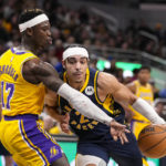 
              Indiana Pacers guard Andrew Nembhard (2) drives on Los Angeles Lakers guard Dennis Schroder (17) during the second half of an NBA basketball game in Indianapolis, Thursday, Feb. 2, 2023. The Lakers defeated the Pacers 112-111. (AP Photo/Michael Conroy)
            