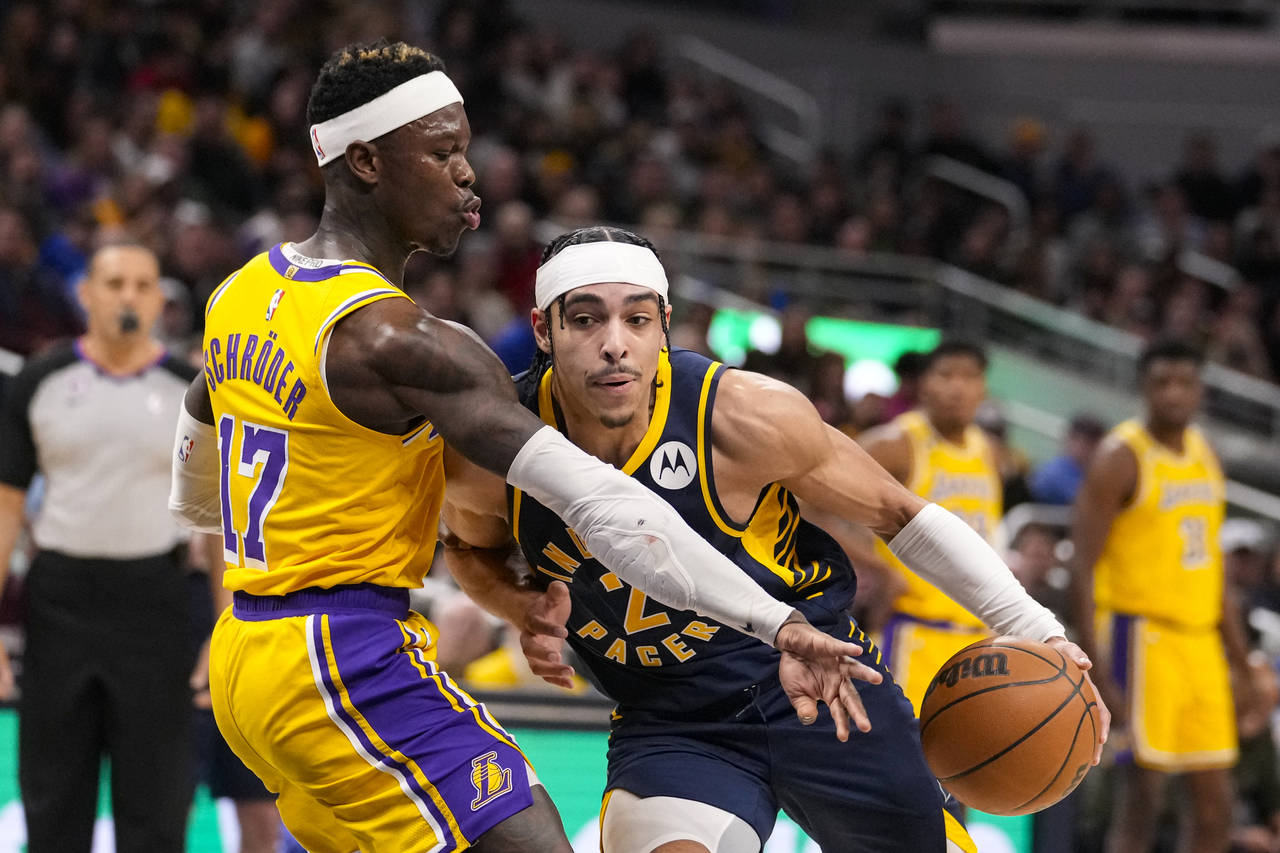 Indiana Pacers guard Andrew Nembhard (2) drives on Los Angeles Lakers guard Dennis Schroder (17) du...