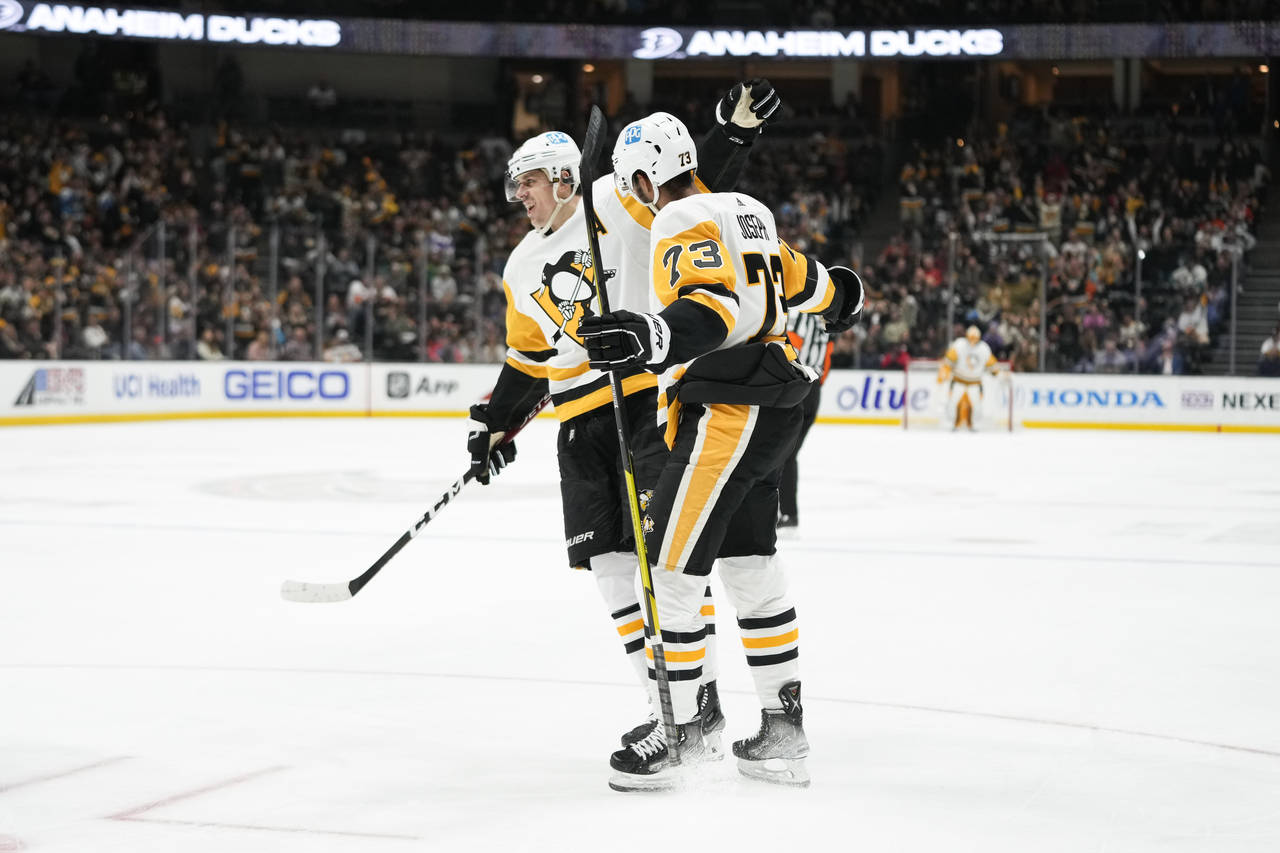 Pittsburgh Penguins' Pierre-Olivier Joseph (73) and Evgeni Malkin (71) celebrate after a goal by Jo...