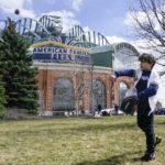 
              FILE - Lennon Jones plays catch outside American Family Field before the Milwaukee Brewers' home opener against the St. Louis Cardinals, April 14, 2022, in Milwaukee. Wisconsin Gov. Tony Evers' office announced Tuesday, Feb. 14, 2023, that he wants to hand the Milwaukee Brewers nearly $300 million from Wisconsin's budget surplus to enact repairs and renovations on American Family Field. (AP Photo/Morry Gash, File)
            