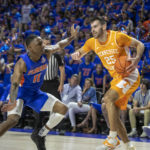 
              Florida guard Kyle Lofton (11) goes after Tennessee guard Santiago Vescovi (25) during the first half of an NCAA college basketball game, Wednesday, Feb. 1, 2023, in Gainesville, Fla. (AP Photo/Alan Youngblood)
            
