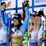 
              Italy's Marta Bassino, winner of an alpine ski, women's World Championships super G, celebrates on the podium with second-placed United States' Mikaela Shiffrin, left, and joint third-placed Austria's Cornelia Huetter, second from right, and Norway's Kajsa Vickhoff Lie, right, in Meribel, France, Wednesday, Feb. 8, 2023. (AP Photo/Alessandro Trovati)
            