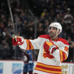 
              Calgary Flames center Nazem Kadri acknowledges the applause of the crowd after a video tribute was played on the overhead scoreboard to show Kadri's contributions to winning the Stanley Cup as a member of the Colorado Avalanche, during the first period of an NHL hockey game Saturday, Feb. 25, 2023, in Denver. (AP Photo/David Zalubowski)
            