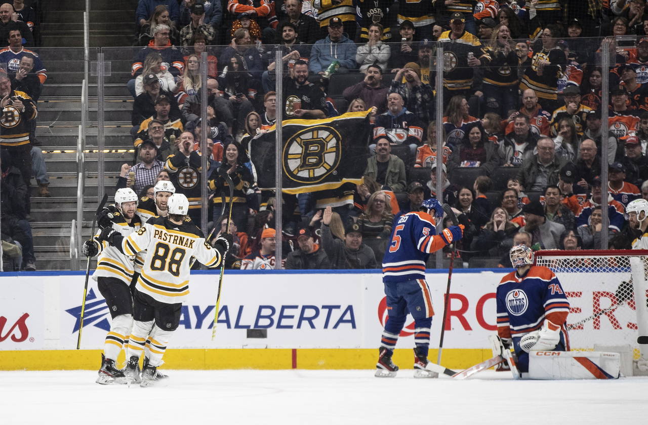 Boston Bruins, left, celebrate after a goal against the Edmonton Oilers during second-period NHL ho...