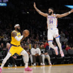 
              Los Angeles Lakers forward LeBron James, left, tries to pass as Oklahoma City Thunder forward Kenrich Williams defends during the second half of an NBA basketball game Tuesday, Feb. 7, 2023, in Los Angeles. (AP Photo/Ashley Landis)
            