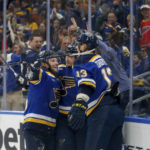 
              St. Louis Blues' Alexey Toropchenko (13) is congratulated by teammates after scoring a goal against the New Jersey Devils during the second period of an NHL hockey game Thursday, Feb. 16, 2023, in St. Louis. (AP Photo/Scott Kane)
            