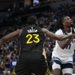 
              Minnesota Timberwolves center Naz Reid is fouled by Golden State Warriors forward Draymond Green (23) during the first half of an NBA basketball game, Wednesday, Feb. 1, 2023, in Minneapolis. (AP Photo/Abbie Parr)
            