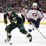 
              Minnesota Wild left wing Kirill Kaprizov (97), left, skates with the puck against Columbus Blue Jackets center Boone Jenner (38) during the first period of an NHL hockey game Sunday, Feb. 26, 2023, in St. Paul, Minn. (AP Photo/Abbie Parr)
            