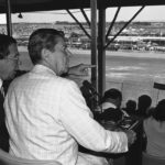 
              FILE - President Ronald Reagan, front right, sits with William France Jr., president of NASCAR and part owner of the Daytona Speedway, and watches the running of the Firecracker 400 stock car race July 4, 1984, in Daytona Beach, Fla. NASCAR marks its 75th year in 2023, recalling both its highs and lows. (AP Photo/Ira Schwarz, File)
            