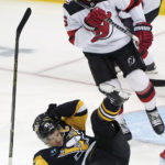 
              Pittsburgh Penguins center Sidney Crosby (87) gets tripped by New Jersey Devils defensman John Marino (6) during the first period of an NHL hockey game in Pittsburgh, Saturday, Feb. 18, 2023. (AP Photo/Matt Freed)
            