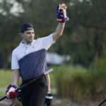 
              Nick Suzuki of the Montreal Canadiens, raises his hand after winning the golf skills competition, Wednesday, Feb. 1, 2023, in Plantation, Fla. The event was part of the NHL All Star weekend. To the right is Arizona Coyotes forward Clayton Kellar. (AP Photo/Marta Lavandier)
            