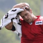 
              FILE - New England Patriots quarterback Tom Brady wipes the sweat from his head during an NFL football training camp in Foxborough, Mass., July 30, 2015.  Brady, the seven-time Super Bowl winner with New England and Tampa Bay, announced his retirement from the NFL on Wednesday, Feb. 1, 2023 exactly one year after first saying his playing days were over, by posting a brief video lasting just under one minute on social media. (AP Photo/Charles Krupa)
            