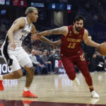 
              Cleveland Cavaliers guard Ricky Rubio (13) drives against San Antonio Spurs forward Jeremy Sochan (10) during the first half of an NBA basketball game, Monday, Feb. 13, 2023, in Cleveland. (AP Photo/Ron Schwane)
            