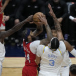 
              New Orleans Pelicans forward Brandon Ingram (14) goes to the basket between Los Angeles Lakers forward Anthony Davis (3) and guard Patrick Beverley (21) in the first half of an NBA basketball game in New Orleans, Saturday, Feb. 4, 2023. (AP Photo/Gerald Herbert)
            