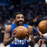 
              Dallas Mavericks guard Kyrie Irving, left, jokes with center JaVale McGee, right, during warmups prior to an NBA basketball game against the San Antonio Spurs, Thursday, Feb. 23, 2023, in Dallas. (AP Photo/Emil T. Lippe)
            