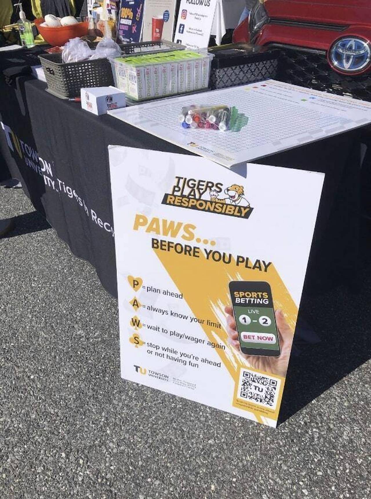 A poster urging Towson University students to gamble responsibly is displayed at a table outside Jo...