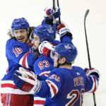 
              New York Rangers' Mika Zibanejad (93) celebrates with teammate Artemi Panarin (10) and Jimmy Vesey (26) after scoring a goal during the third period of an NHL hockey game against the Vancouver Canucks Wednesday, Feb. 8, 2023, in New York. The Rangers won 4-3. (AP Photo/Frank Franklin II)
            