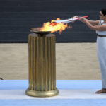 
              FILE - Greek actress Xanthi Georgiou, playing the role of High Priestess, lights the torch with the flame during the Olympic flame handover ceremony at Panathinean stadium in Athens, Greece, Tuesday, Oct. 19, 2021. Instead of arriving overland, the symbolic flame alighting the Paris 2024 Games will take to the seas from its birthplace in Greece, arriving aboard a three-masted tall ship in the French port of Marseille. Paris 2024 organizers announced the flame's journey Friday Feb.3, 2023 at City Hall in Marseille, a former Greek colony founded 2,600 years ago. (AP Photo/Petros Giannakouris, File)
            