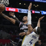 
              Los Angeles Clippers forward Norman Powell, left, shoots as Golden State Warriors guard Moses Moody defends during the second half of an NBA basketball game Tuesday, Feb. 14, 2023, in Los Angeles. (AP Photo/Mark J. Terrill)
            