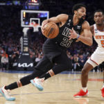
              Brooklyn Nets guard Spencer Dinwiddie (26) drives against New York Knicks guard Immanuel Quickley (5) during the first half of an NBA basketball game, Monday, Feb. 13, 2023, in New York. (AP Photo/Jessie Alcheh)
            