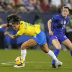 
              Brazil forward Bia Zaneratto (16) loses her footing after a foul by United States midfielder Andi Sullivan (17) during the first half of a SheBelieves Cup soccer match Wednesday, Feb. 22, 2023, in Frisco, Texas. (AP Photo/LM Otero)
            