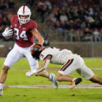 STANFORD, CALIFORNIA - OCTOBER 08: Benjamin Yurosek #84 of the Stanford Cardinal running with the ball after catching a pass fights off the tackle of Jaydon Grant #3 of the Oregon State Beavers in the first quarter at Stanford Stadium on October 08, 2022 in Stanford, California. (Photo by Thearon W. Henderson/Getty Images)