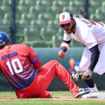 TAICHUNG, TAIWAN - MARCH 10: Jose Caballero #77 of Team Panama attempt to tag out Yoán Moncada #10 of Team Cuba at the top of the 3rd inning during the World Baseball Classic Pool A game between Cuba and Panama at Taichung Intercontinental Baseball Stadium on March 10, 2023 in Taichung, Taiwan. (Photo by Gene Wang/Getty Images)