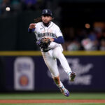 SEATTLE, WASHINGTON - MARCH 30: J.P. Crawford #3 of the Seattle Mariners throws to first base during the third inning against the Cleveland Guardians during Opening Day at T-Mobile Park on March 30, 2023 in Seattle, Washington. (Photo by Steph Chambers/Getty Images)