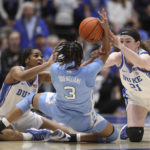 
              North Carolina's Kennedy Todd-Williams (3) looks to pass under pressure from Duke's Ashlon Jackson and Kennedy Brown during the first half of an NCAA college basketball game Sunday, Feb. 26, 2023, in Durham, N.C. (Kaitlin McKeown/The News & Observer via AP)
            