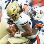 AUBURN, ALABAMA - SEPTEMBER 04: Defensive end Derick Hall #29 of the Auburn Tigers sacks quarterback Kato Nelson #1 of the Akron Zips during the first quarter of play at Jordan-Hare Stadium on September 04, 2021 in Auburn, Alabama. (Photo by Michael Chang/Getty Images)