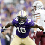 SEATTLE, WASHINGTON - SEPTEMBER 04: Edefuan Ulofoshio #48 of the Washington Huskies reacts during the third quarter against the Montana Grizzlies at Husky Stadium on September 04, 2021 in Seattle, Washington. (Photo by Steph Chambers/Getty Images)
