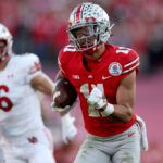 PASADENA, CALIFORNIA - JANUARY 01: Jaxon Smith-Njigba #11 of the Ohio State Buckeyes carries the ball after a reception during the first half against the Utah Utes in the Rose Bowl Game at Rose Bowl Stadium on January 01, 2022 in Pasadena, California. (Photo by Harry How/Getty Images)