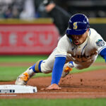 SEATTLE, WASHINGTON - APRIL 16: Kolten Wong #16 of the Seattle Mariners dives back to first base during the third inning against the Colorado Rockies at T-Mobile Park on April 16, 2023 in Seattle, Washington. (Photo by Alika Jenner/Getty Images)