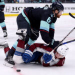 SEATTLE, WASHINGTON - APRIL 24: Adam Larsson #6 of the Seattle Kraken pushes Evan Rodrigues #9 of the Colorado Avalanche during the third period in Game Four of the First Round of the 2023 Stanley Cup Playoffs at Climate Pledge Arena on April 24, 2023 in Seattle, Washington. (Photo by Steph Chambers/Getty Images)