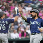 DETROIT, MICHIGAN - MAY 12: Jose Caballero #76 and J.P. Crawford #3 of the Seattle Mariners celebrate scoring runs together against the Detroit Tigers during the top of the second inning at Comerica Park on May 12, 2023 in Detroit, Michigan. (Photo by Nic Antaya/Getty Images)