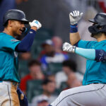 ATLANTA, GA - MAY 20: Eugenio Suarez #28 of the Seattle Mariners reacts after a two-run home run with Julio Rodriguez #44 during the seventh inning against the Atlanta Braves at Truist Park on May 20, 2023 in Atlanta, Georgia. (Photo by Todd Kirkland/Getty Images)