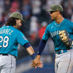 ATLANTA, GA - MAY 20: Eugenio Suarez (L) #28 of the Seattle Mariners celebrates with teammate Julio Rodriguez #44 at the conclusion of the 7-3 victory over the Atlanta Braves at Truist Park on May 20, 2023 in Atlanta, Georgia. (Photo by Todd Kirkland/Getty Images)
