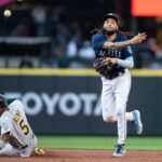 SEATTLE, WA - MAY 24: J.P. Crawford #3 of the Seattle Mariners attempts to turn a double play after forcing out Tony Kemp #5 of the Oakland Athletics at second base during the third inning at T-Mobile Park on May 24, 2023 in Seattle, Washington. (Photo by Stephen Brashear/Getty Images)