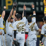 SEATTLE, WA - MAY 26: (L-R) Andrew McCutchen #22 of the Pittsburgh Pirates, Austin Hedges #18, Ke'Bryan Hayes #13, Duane Underwood Jr., Carlos Santana #41, and Jack Suwinski #65 of the Pittsburgh Pirates celebrate after a game against the Seattle Mariners at T-Mobile Park on May 26, 2023 in Seattle, Washington. The Pirates won 11-6. (Photo by Stephen Brashear/Getty Images)
