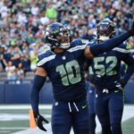 SEATTLE, WASHINGTON - SEPTEMBER 25: Uchenna Nwosu #10 of the Seattle Seahawks reacts after recovering a fumble against the Atlanta Falcons during the fourth quarter at Lumen Field on September 25, 2022 in Seattle, Washington. (Photo by Jane Gershovich/Getty Images)