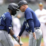 OAKLAND, CALIFORNIA - MAY 04: Taylor Trammell #5 of the Seattle Mariners is congratulated by third base coach Manny Acta #14 after Trammell hit a two-run home run against the Oakland Athletics in the top of the second inning at RingCentral Coliseum on May 04, 2023 in Oakland, California. (Photo by Thearon W. Henderson/Getty Images)