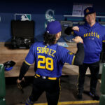 SEATTLE, WASHINGTON - MAY 05: Eugenio Suarez #28 greets manager Scott Servais #9 of the Seattle Mariners before the game against the Houston Astros at T-Mobile Park on May 05, 2023 in Seattle, Washington. (Photo by Steph Chambers/Getty Images)
