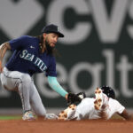 BOSTON, MASSACHUSETTS - MAY 15: JP Crawford #3 of the Seattle Mariners tags out Pablo Reyes #19 of the Boston Red Sox on a stolen base attempt in the fifth inning at Fenway Park on May 15, 2023 in Boston, Massachusetts. (Photo by Paul Rutherford/Getty Images)