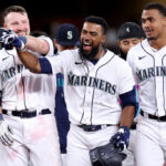SEATTLE, WASHINGTON - MAY 31: Cal Raleigh #29 of the Seattle Mariners celebrates his walk-off single with Teoscar Hernandez #35 and Julio Rodriguez #44 during the tenth inning against the New York Yankees at T-Mobile Park on May 31, 2023 in Seattle, Washington. (Photo by Steph Chambers/Getty Images)