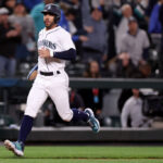 SEATTLE, WASHINGTON - MAY 31: Jose Caballero #76 of the Seattle Mariners scores the winning run on a walk-off single by Cal Raleigh #29 against the New York Yankees during the tenth inning at T-Mobile Park on May 31, 2023 in Seattle, Washington. (Photo by Steph Chambers/Getty Images)